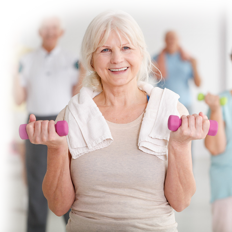 rehab therapist talking to a resident in the rehab gym